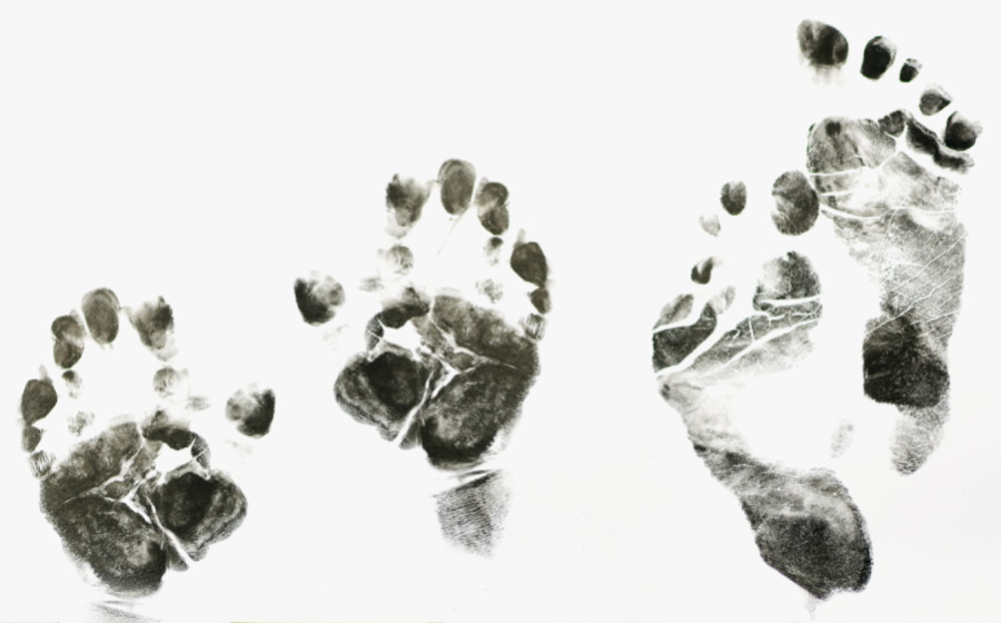 Imprint of hands and feet on white background